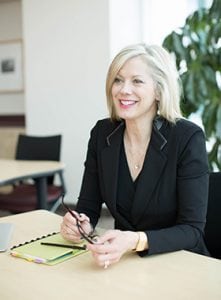 Career Coach Kim Monaghan sitting at a desk